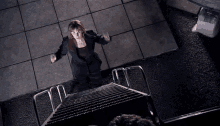 a woman is standing on a set of metal stairs