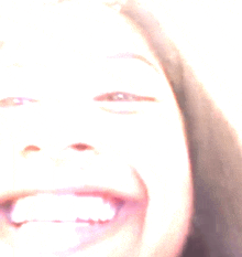 a close up of a woman 's face with a blurred background