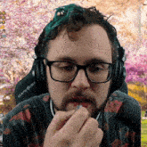 a man wearing glasses and headphones with the word dxracer on them
