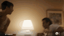 a blurry picture of a man and woman with the hashtag #thisisus on the bottom