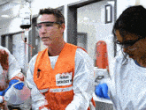 a man in an orange vest that says primary emergency medicine