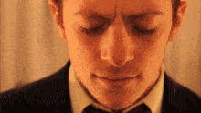 a close up of a man 's face with his eyes closed and his mouth open