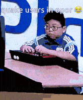 a boy is playing a video game with the words quake users in opor behind him