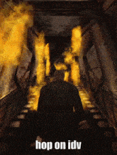 a man is standing in a hallway with fire coming out of the walls and stairs .