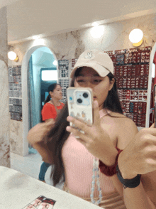 a woman taking a picture of herself with her phone