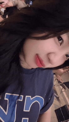 a girl wearing a blue shirt that says ' srs ' on it