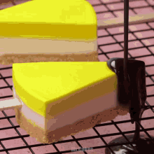 a slice of cake on a stick is being covered in chocolate sauce