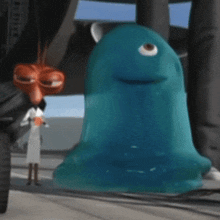 a cartoon character is standing next to a blue blob with one eye