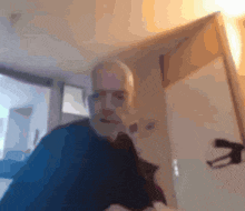 a blurry picture of a man taking a selfie in a room
