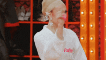 a woman is wearing a white robe with the word rupaul on it