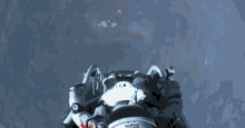 a man wearing a red bull helmet is flying in the air