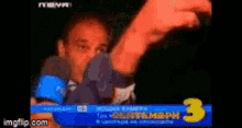 a man is giving a thumbs up in front of a sign that says 3 on it