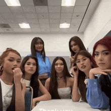 a group of young women are posing for a picture with the words thank you on the table