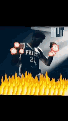 a man in a philadelphia basketball jersey is standing in front of a fire .