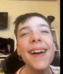 a young man with braces on his teeth smiles at the camera