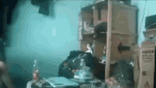 a person is sitting at a table in a room with a bottle of water on it .
