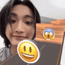 a man is holding a smiley face in front of him