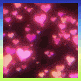 a bunch of pink hearts are on a dark background