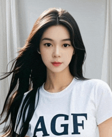 a woman wearing a white t-shirt with the word agf on it