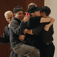 a group of people hugging each other with zky written on the bottom of the photo