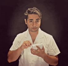 a man in a lab coat is holding a piece of paper
