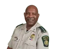 a man in a sheriff 's uniform has a patch on his arm that says sheriff