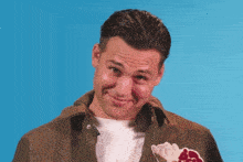 a man wearing a jacket with an ice cream cone on it makes a face