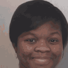a close up of a woman 's face smiling
