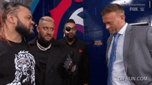 a group of men standing in front of a smackdown sign