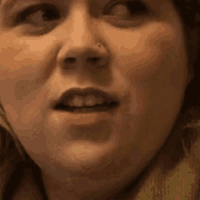 a close up of a woman 's face with her mouth open .