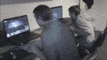 two people are playing a video game on their laptops