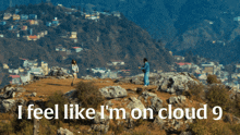 a man and a woman standing on top of a hill with the words i feel like i 'm on cloud 9 below them