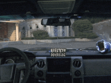 a car with a sign that says dirty work on the dashboard