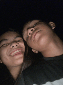 a boy and a girl are smiling for the camera