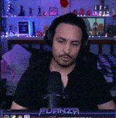 a man wearing headphones stands in front of a microphone with the word fuanza on the bottom right
