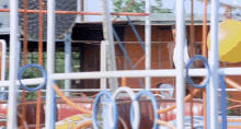 a person is riding a roller coaster in a playground