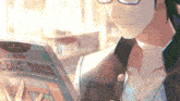 a man wearing glasses is reading a book in a library