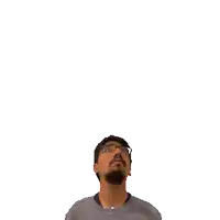 a man with glasses and a beard looks up at a green cross above his head