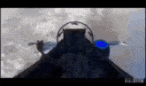 a fighter jet is flying through the air with a person in the cockpit .
