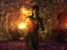 a man in a red tank top is holding a knife and a torch in a cave