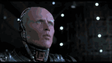 a woman in a leather jacket looks at a robot in a dark room