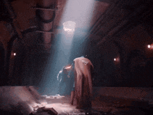 a man in a superman costume is standing in a dark room