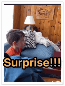 a boy sitting on a couch with the words surprise written on the bottom