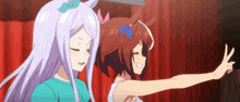 two anime girls are standing next to each other with one pointing