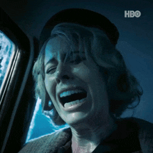 a woman is screaming in a dark room with hbo written on the bottom