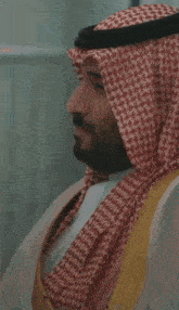 a man with a beard wearing a red and white scarf