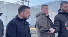 a group of men are standing in front of a building that says radio svobodo