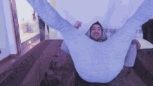 a man is laying on a bed with his legs up in the air