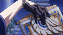 a person in a black glove is holding a book with a blue and gold design