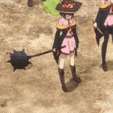 a girl in a witch hat is holding a black object with spikes on it